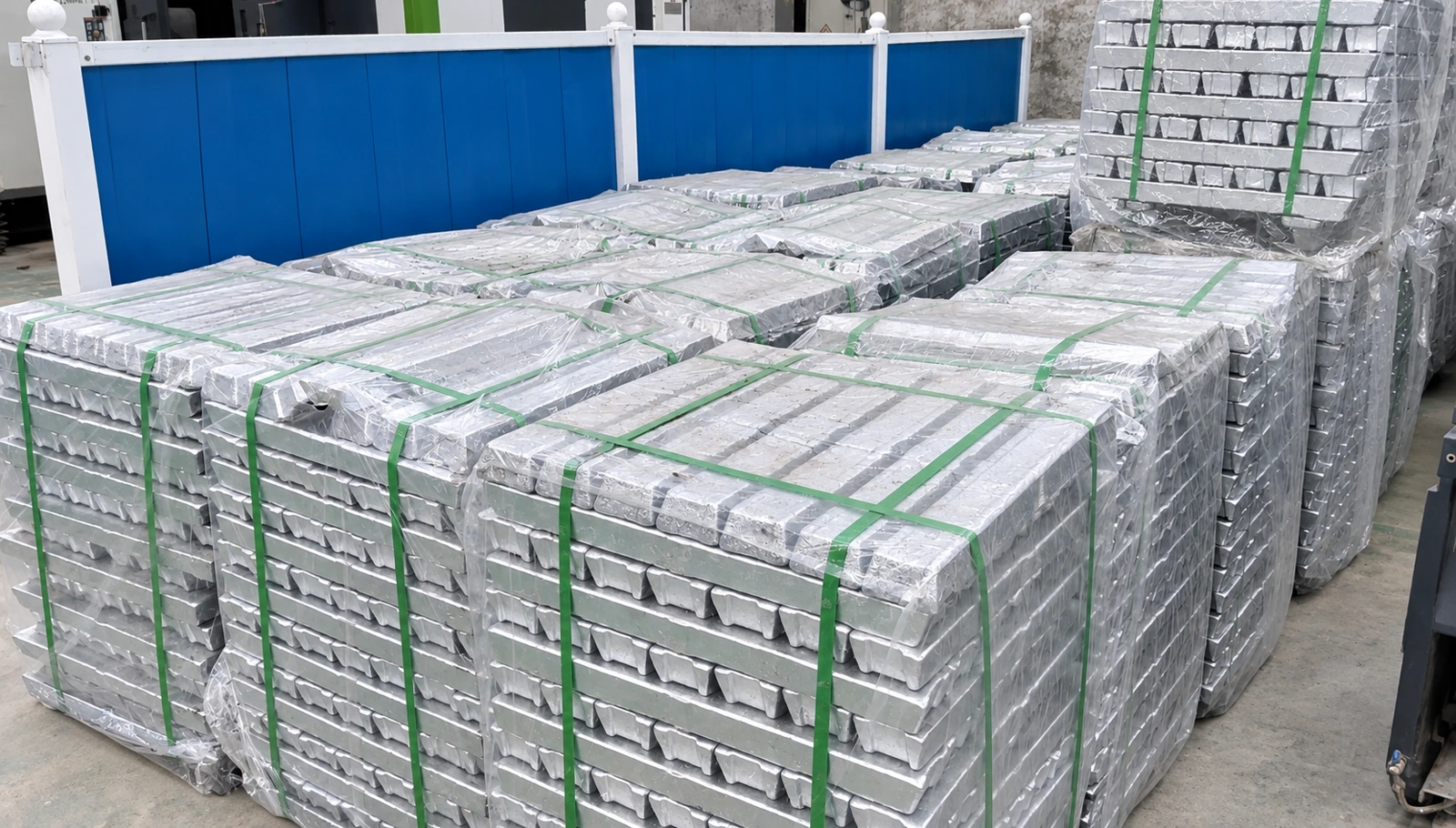 Bundled metal ingots arranged in a material storage area.