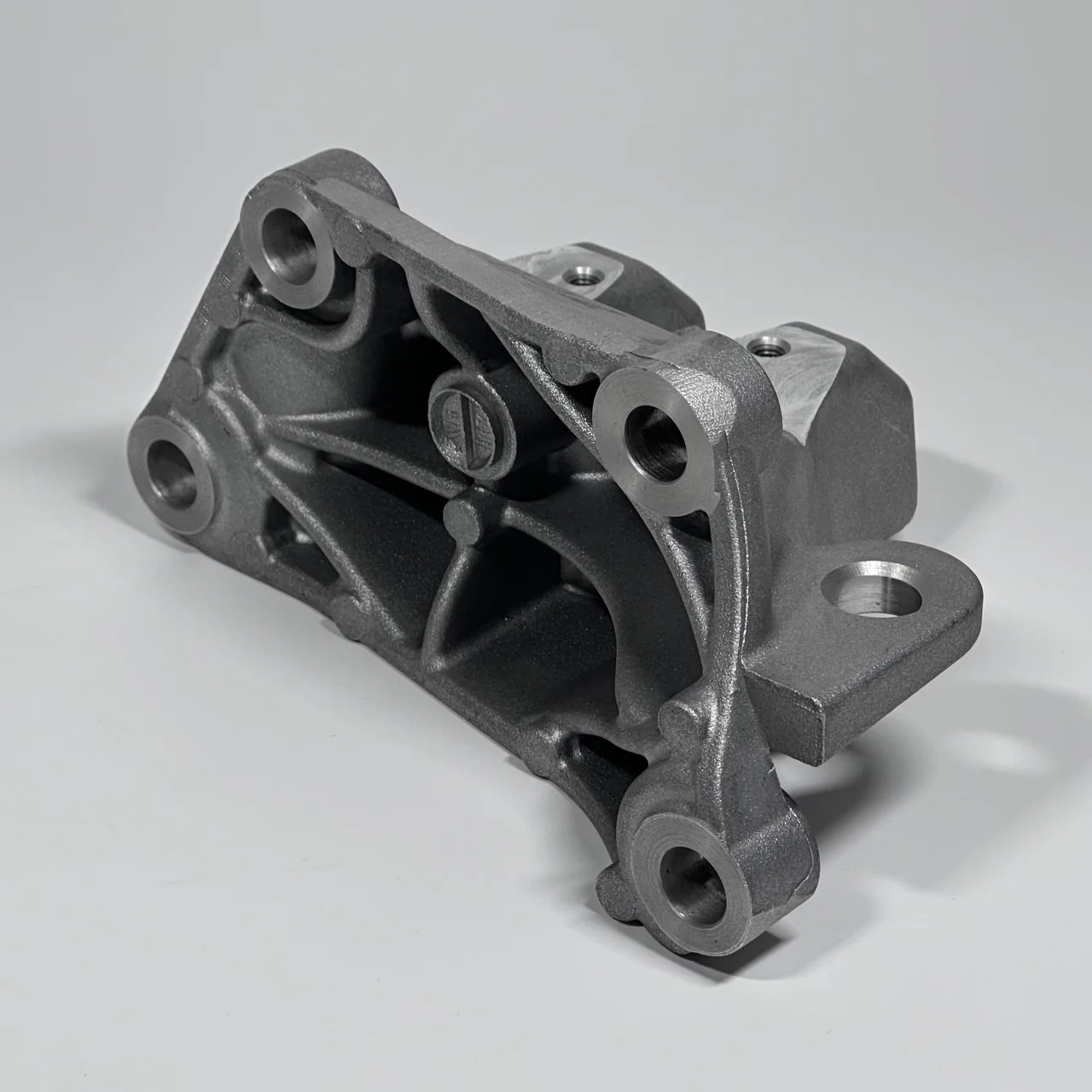 Ribbed bracket casting with several mounting interfaces.